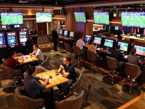 Betting enthusiasts enjoying live sports action while placing wagers at BK8's stylish lounge